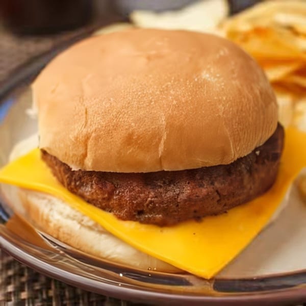 A Steak-Out Charbroiled Delivery cheeseburger with a beef patty and melted cheese on a bun.